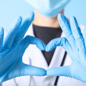 A positive travel nurse experience depicted by a nurse making a heart