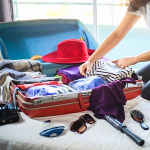 travel nursing myths discussed as a woman unpacks her luggage